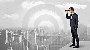 Man looking forward from the top of a skyscraper