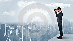 Man looking forward from the top of a skyscraper