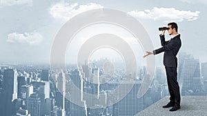 Man looking forward from the top of a skyscraper