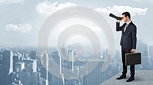 Man looking forward from the top of a skyscraper