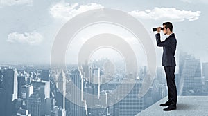 Man looking forward from the top of a skyscraper