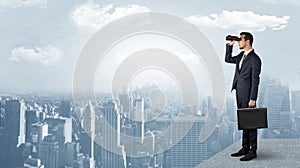 Man looking forward from the top of a skyscraper