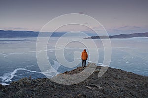 Man Looking on Frozen Lake Baikal in Winter. Olkhon Island, Russia