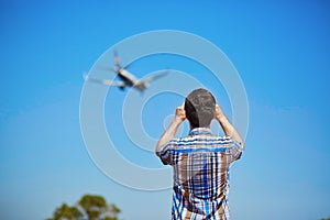 Man is looking at the glide path and landing plane