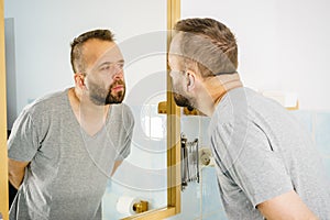 Man looking at himself in mirror