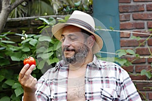 Man looking at his tomato