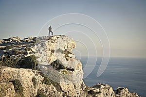 Man looking the horizon from a rock