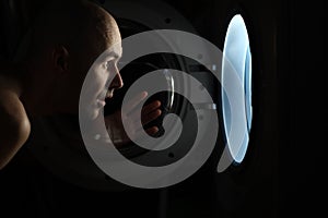 Man looking inside washing machine