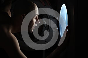 Man looking inside washing machine