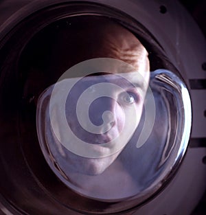 Man looking inside washing machine