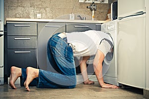 Man Looking inside the washing machine