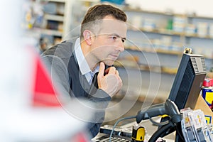 Man looking at laptop in warehouse