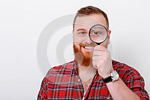 Man looking at magnifying glass