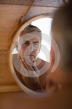 Man looking at mirror in cottage