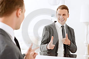 Man looking in mirror and pointing on himself