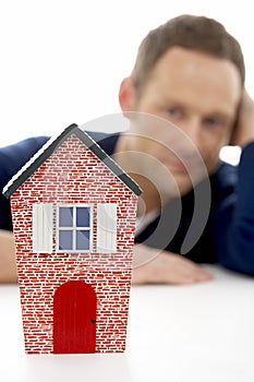 Man Looking At Model House