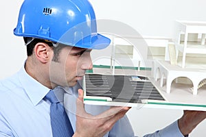 Man looking at model house