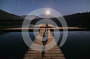 Man Looking At Moon on Dock in Whistler