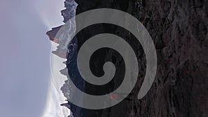 Man Looking at Mount Fitz Roy and Cerro Torre. Patagonia, Argentina. Aerial View. Vertical Video