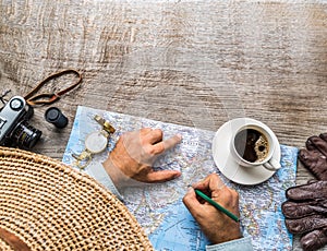 Man looking for new travel destinations on the world map photo