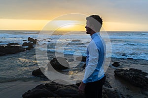 Man Looking Ocean Horizon Rocks Silhouetted