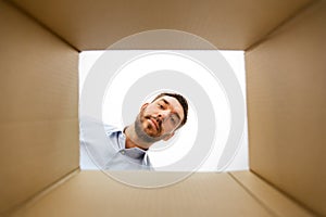 Man looking into open parcel box