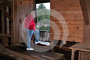 Man looking out doorway of Watsons Mill covered br