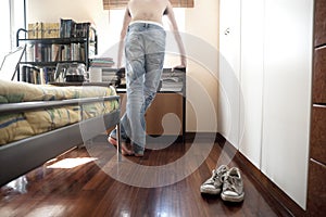 Man looking out of his bedroom window