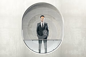 Man looking out of round window