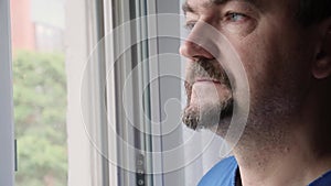 A man looking out the window close-up