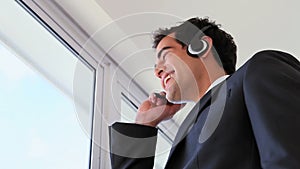 Man looking outside while calling with a headset