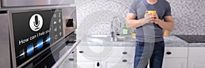 Man Looking At Oven With Voice Recognition Function