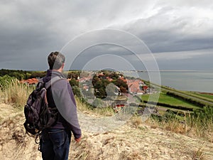 Man looking over  Vlieland from a top of a dune photo