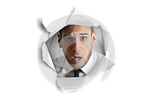 Man looking through a paper hole