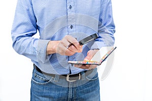 Man looking at a paper notebook with a magnifying glass. Copy space