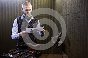 Man looking at paper target checking target hit at firing range