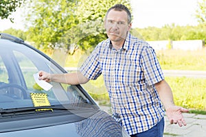 Man looking on parking ticket