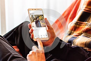 Man looking at photo sharing app on mobile phone