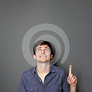 Man looking and pointing up to copy space