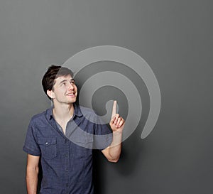 Man looking and pointing up to copy space