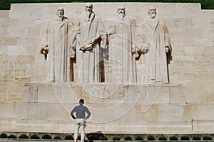 Man looking at Reformation Wall monument