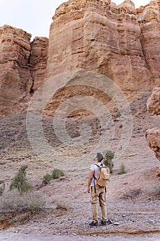 Man looking at the rocks in Charyn canyon near Almaty city, Kazakhstan