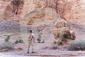Man looking at the rocks in Charyn canyon near Almaty city, Kazakhstan