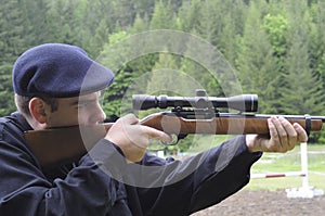 Man looking through scope on