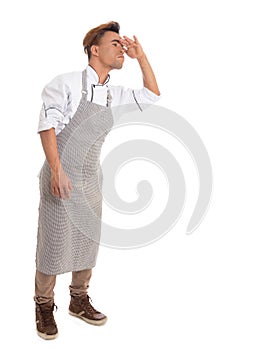 Man is looking for something. Black cook wears apron. Isolated o