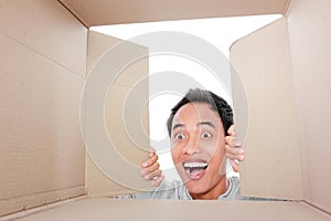 Man looking for something inside box