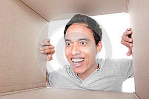 Man looking for something inside box