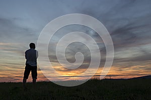 A Man looking at the sunset