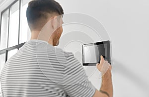 Man looking at tablet computer at smart home