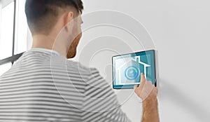 Man looking at tablet computer at smart home